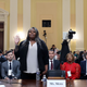 Wandrea ArShaye “Shaye” Moss, former Georgia election worker, is sworn in as her mother Ruby Freeman (in red) watches during the fourth hearing held by the Select Committee to Investigate the January 6 Attack on the U.S. Capitol on June 21, 2022, in the Cannon House Office Building in Washington, DC.